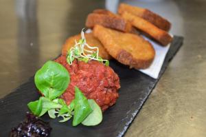 a plate of food with meatballs and french fries at Hotel Lužnice in Planá nad Lužnicí