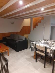 a living room with a couch and a table at Gîtes de la vallée des gaves in Préchac