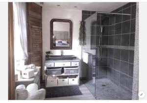 a bathroom with a sink and a shower with a mirror at Casa Mia in Saint-Gervais-les-Bains