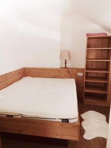 a bedroom with a bed and a book shelf at Ferienwohnung Cooldog Kuschelnest in Imst
