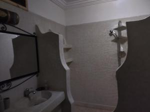 a bathroom with a sink and a mirror and a shower at Riad Gabsi Dades in Boumalne