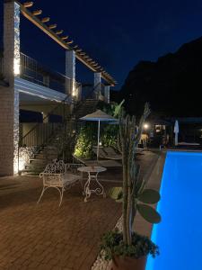 a villa with a swimming pool at night at Residence Segattini in Riva del Garda