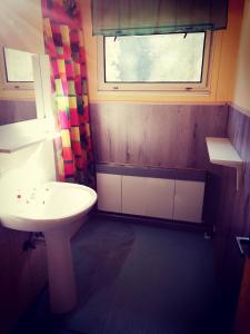 a bathroom with a sink and a window at Penzion Poslední míle in Milovy