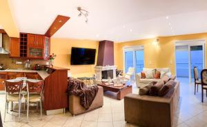 a living room with a couch and a table at BLUE CAVE LUXURY MAISONETTE View to the Corinthian Sea in Xylokastro