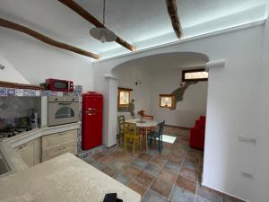 a kitchen with a red refrigerator and a table at Canne al vento in Quartu SantʼElena +19 photos