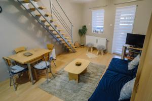 a living room with a couch and a table at Košuta 21 Center Duplex Apartment, Brzeće in Brzeće