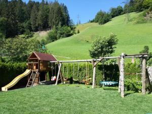 a playground in a field with a slide at Appartement Fritzenwallner in Wagrain