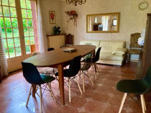 a living room with a wooden table and chairs at Appartement La Marmotte Compreignac in Compreignac