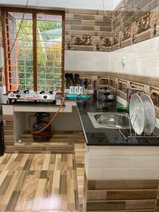 a kitchen with a sink and a counter at BLUE SOPHY Residency in Varkala