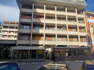 a large building with cars parked in front of it at Maison Claudio CIR VDA-AOSTA- n 0202 in Aosta