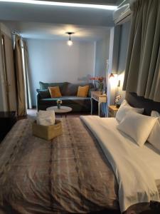 a hotel room with a bed, chair, and nightstand at Central Rooms in Kalamata
