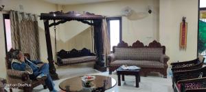 a woman sitting in a living room with a mirror at Ganga Monastery in Varanasi