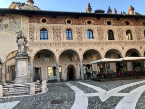 a large building with a statue in front of it at N°30 CHARME Apartments in Vigevano