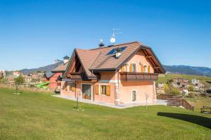 a house on a hill with a green field at Villa Belmonte in Tresché Conca