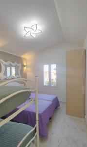 a bedroom with two bunk beds and a window at Villa Miami in Bibione
