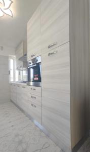a kitchen with wooden cabinets and a stove at Villa Miami in Bibione