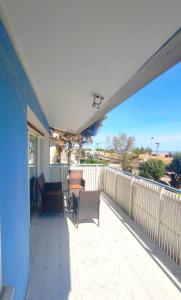 a balcony with chairs and tables on a house at Villa Miami in Bibione