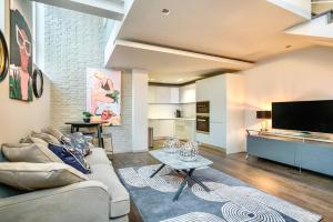 a living room with a couch and a table at Be London - Holborn Boutique Residences in London