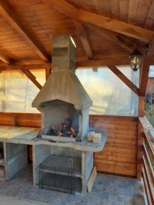 an outdoor pizza oven in a wooden roof at Apartament Laura in Bran