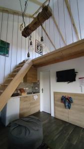 an attic room with a staircase and a tv at Brvnare Ljubojević in Kraljevo