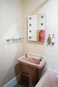 a bathroom with a sink and a mirror at Fox & Hounds Hotel in Lydford