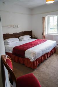 מיטה או מיטות בחדר ב-Fox & Hounds Hotel