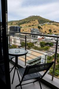 a balcony with a table and a view of a city at 2218 at 16 on Bree in Cape Town