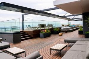 a rooftop deck with furniture and views of the ocean at 2218 at 16 on Bree in Cape Town