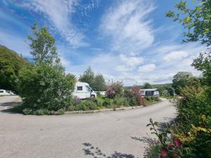 a road with a van parked on the side at Two Bedroom Barn Conversion in Newquay