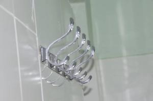 a chrome towel rack on a wall in a bathroom at Summer Dream Lodge in Paje