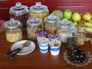 a table with jars of food and fruit on it at B&B Sunnesite Pratteln in Pratteln