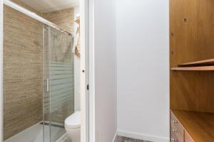 Un baño con ducha de cristal y un inodoro. en Loft Gracia- CTH Granada, en Granada