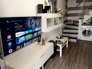 a living room with a large tv on a wall at Maspalomas Bungalow C I in Maspalomas