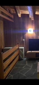 a room with a toilet and a wooden wall at chalet à diolly in Savièse