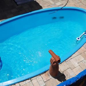 a swimming pool with a toy gun in the water at Casa Praia de Carapibus 70m da beira mar Conde João Pessoa PB in Jacumã