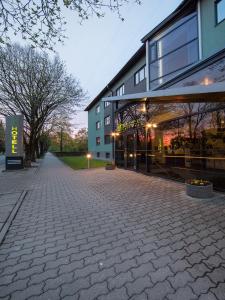 a building with a brick sidewalk in front of a building at Arabella Hotel in Kuressaare