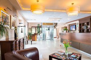 a lobby with a waiting room and a lobby at Aventinus Hotel in Nyíregyháza