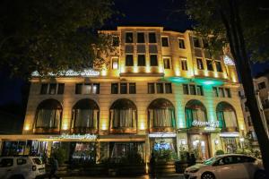 a lit up building with cars parked in front of it at Ottoman's Life Hotel S Class in Istanbul