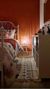 a bedroom with a bed and a table with a lamp at Gîte Saint Martin in Carvin