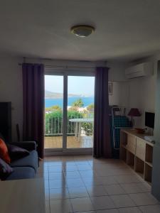 a living room with a view of the ocean at Studio cabine Thalacap Vue mer in Banyuls-sur-Mer