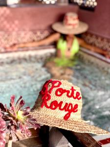 a straw hat sitting next to a swimming pool at Riad La Porte Rouge in Marrakesh