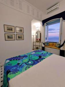 a bedroom with a large bed and a window at Villa Marunnella in Praiano +40 photos