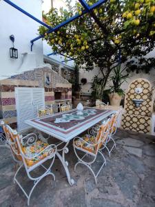 a table and chairs sitting under a tree at Villa Marunnella in Praiano