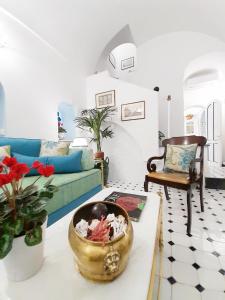 a living room with a couch and a bowl on a table at Villa Marunnella in Praiano