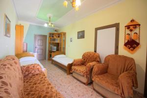 a living room with two chairs and a couch at Vila Agushi in Ksamil +82 photos