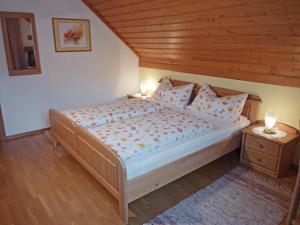 a bedroom with a large bed with a wooden ceiling at Haus Lechthaler in Aflenz Kurort