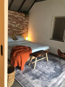 a bedroom with a bed with a blanket on it at B&B Driel in Driel