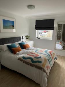 a bedroom with a large bed with a colorful comforter at Beach Apartment, Watergate Bay, Newquay in Newquay