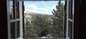 uma janela aberta com vista para uma montanha coberta de neve em La Finestra sul Colle em Rivisondoli