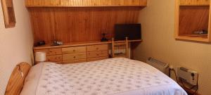 a small bedroom with a bed and a television at La Finestra sul Colle in Rivisondoli